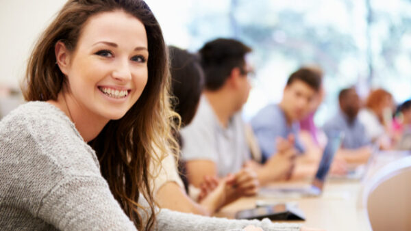 Smiling student with other students in the background