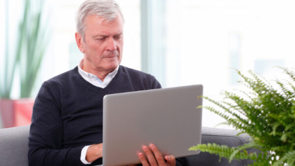Retired professional working on a laptop